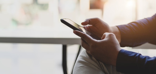 Canvas Print - cropped shot of young businessman using smartphone