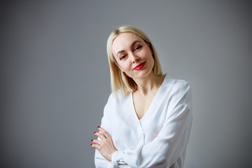 Portrait of beautiful adult woman in white blouse.