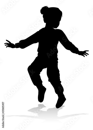 A child in silhouette playi...