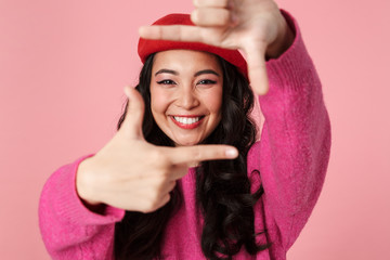 Poster - Image of asian girl smiling and showing photo frame with her fingers