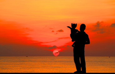 Sticker - silhouette happy  family on the beach at  sunrise time