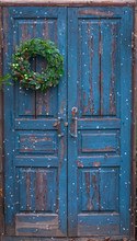 Christmas Handmade Wreath With Green Balls, Cinnamon Sticks, Cones On Blue Wooden Rustic Door