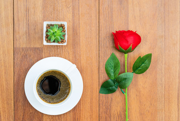 White cup of coffee and red rose valentine concept