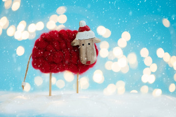 Wall Mural - Snowy sheep (lamb) toy background. Christmas greeting card. Christmas or New Year celebration concept. Copy space