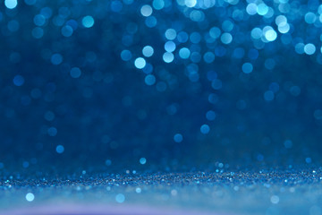 blue sparkling lights festive background with texture. abstract christmas twinkled bright bokeh defo