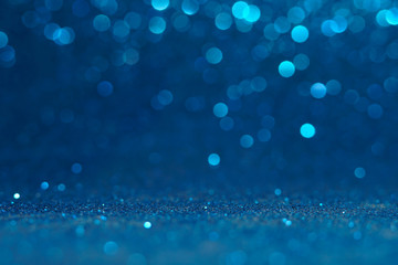 blue Sparkling Lights Festive background with texture. Abstract Christmas twinkled bright bokeh defocused and Falling stars. Winter Card or invitation	