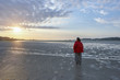 © stock mp - Lonely man standing on the sand of a beach at ebb, evening mood, peaceful feeling