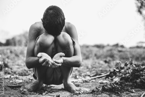 Fotomural poor child or beggar begging you for help sitting at dirty slum