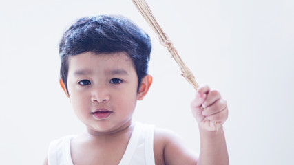 Wall Mural - 2 year old Asian boy Buddhist Holding a holy water in Thailand, standing with his eyes closed, praying for the blessing of the religion, white background image                             