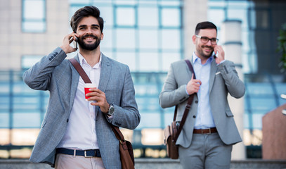 Wall Mural - Business people makes a phone call in front of the corporation. Business, lifestyle concept