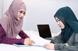 © Watcharin - The muslim business woman doing paper work together,at meeting room,office busy time