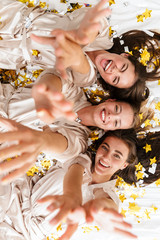 Canvas Print - Girls women friends indoors on bed at the hen party