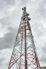 Telecommunication transmission tower,telecommunication mast TV antennas wireless technology with blue sky in the morning,Transmission tower on the Koeterberg mount against sky.