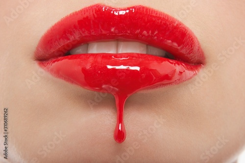 Red Lipgloss Dripping From Woman\'s Lips