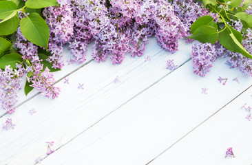 Bouquet of purple lilacs flowers on a light blue shabby wooden background. Vintage floral background with spring flowers.