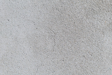 Gray textured cement wall background with fine concrete chips. Construction backgrounds