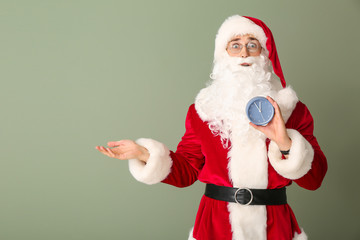 Poster - Surprised Santa with alarm clock on color background. Christmas countdown concept