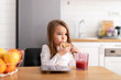 © MIHAJLO CKOVRIC/Stocksy - Young girl eating cookies and playing on her tablet