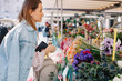 © Liliya Rodnikova/Stocksy - Lovely woman buying flowers at street market