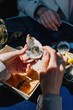 © Liliya Rodnikova/Stocksy - Crop woman eating oyster in restaurant
