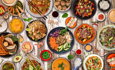 Wall Mural - Asian food background with various ingredients on rustic wooden background , top view. Vietnam or Thai cuisine.