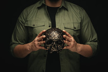 Crop Man Holding Ornamental Metal Skull