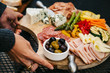 © CWP, LLC/Stocksy - Woman placing crudites on a patio table