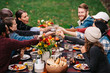 © CWP, LLC/Stocksy - Friends toasting during an outdoor dinner party