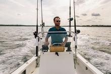Outdoor Active Lifestyle Of Man Driving Boat In Fall