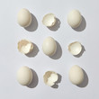 © Yaroslav Danylchenko/Stocksy - Composition of whole eggs and eggshell halves on a gray background with copy space. Flat lay
