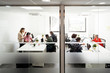 © Santi Nunez/Stocksy - Business group at a workshop in the office