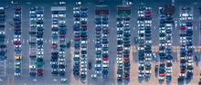 Bird's Eye Aerial View From Drone Parking Lot With Colored Cars On A Gray Asphalt Background. Top View Strictly Above.