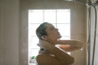 © MIHAJLO CKOVRIC/Stocksy - Young woman taking a shower