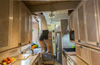 © Carolyn Lagattuta/Stocksy - Man doing electrical work in the kitchen