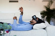 © Ivan Gener/Stocksy - VR headset sofa playing.