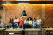 © MyMicrostock/Stocksy - Big group of business people posing in creative office