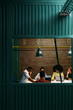 © MyMicrostock/Stocksy - Business group in a meeting room in the office