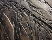 Close Up Beach Sand And Small Rivulets Of Flowing Water At Low Tide, Oregon Coast