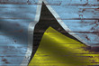 © Pixaprime Alex J - Saint-lucia flag on an old wooden plank forming a background