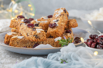 Wall Mural - Granola bar. Healthy snack. Cereal granola bar with nuts, fruit, coconut and cranberries on a christmas table