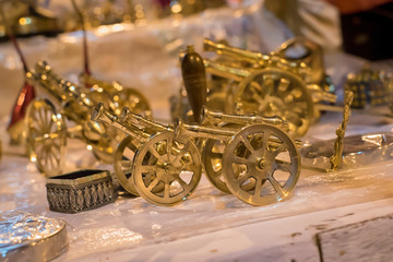 Beautiful handmade toy cannon displayed in a shop for sale in blurred background. Indian handicraft.