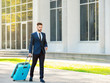 © Pixel-Shot - Young man with luggage for business trip outdoors