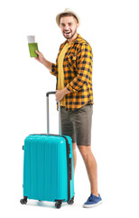 Poster - Young male tourist with luggage on white background