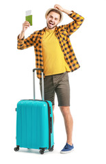 Poster - Young male tourist with luggage on white background