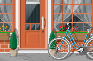 Wall Mural - Vintage house facade. Outdoor city street view. Brick building with entrance door, window with flowers, trees and bicycle. Vector illustration in flat style