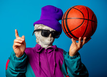 Antique Statue Dressed In Trendy Clothes Of The Nineties Holds Basketball Ball