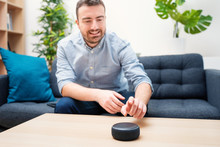 Man Using Home Assistant Bluetooth Speaker