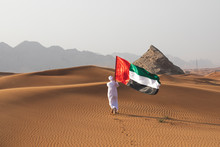Arab Man Holding The UAE Flag In The Desert Celebrating UAE National Day And Uae Flag Day.