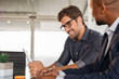 © Rido - Businessmen working together at desk