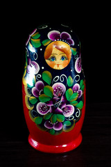 painted nesting doll on a dark background